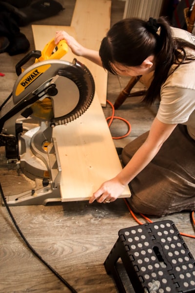 Miter saw cutting a wood plank